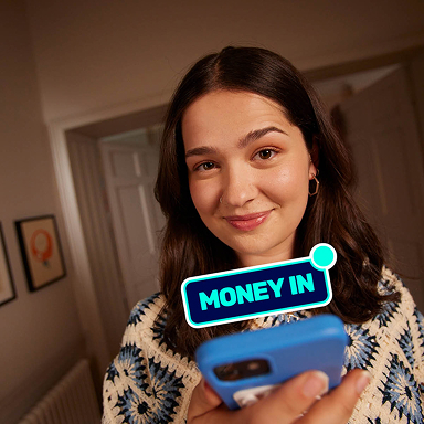 Girl looking at mobile phone with text saying 'money in'