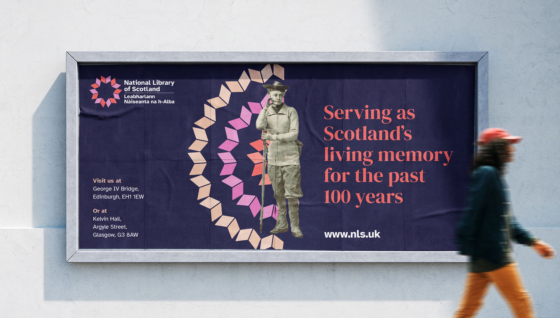 Man walking past a large NLS poster