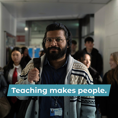 Male teacher walking in class corridor heading to class