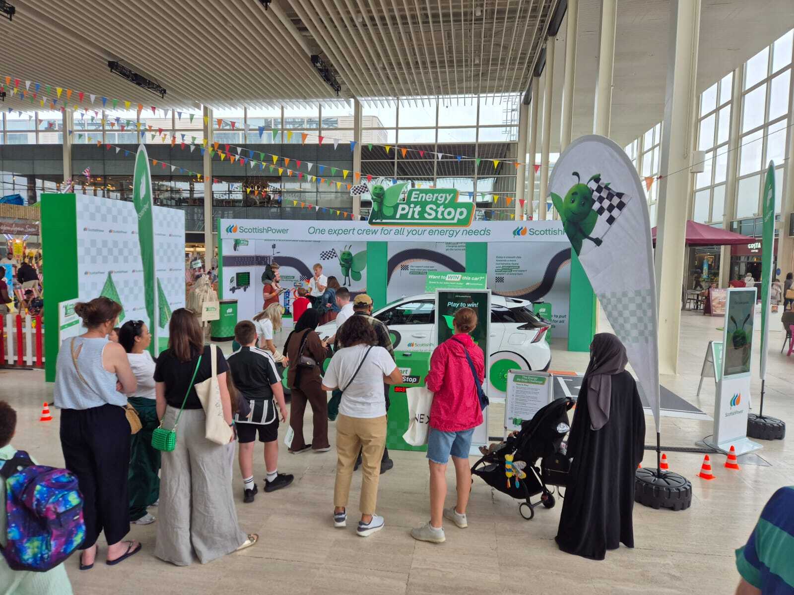 Group of people in front of Scottish Power display unit
