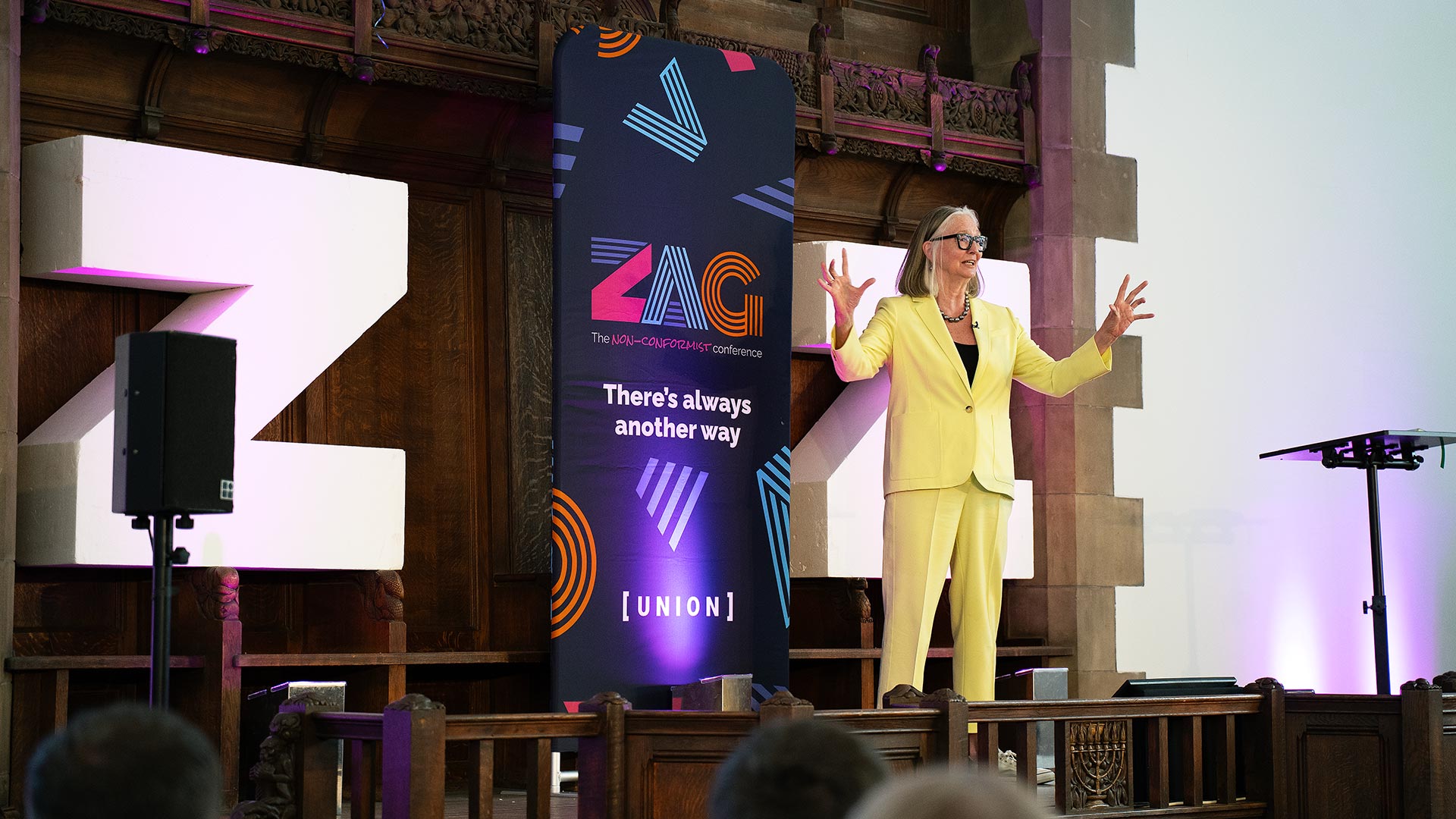 A speaker presenting at ZAG 2025